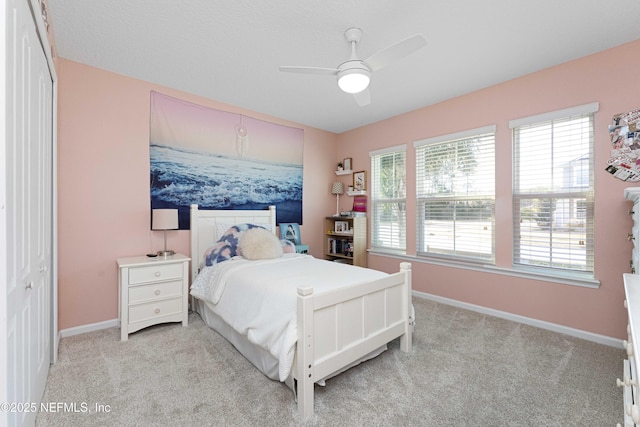 bedroom featuring light carpet, a closet, and ceiling fan