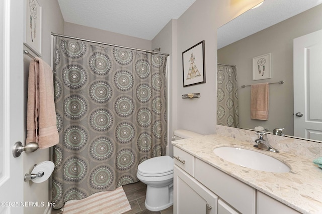 bathroom featuring wood-type flooring, a textured ceiling, toilet, and vanity