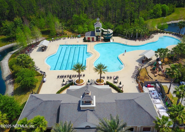 view of swimming pool with a patio area and a water slide