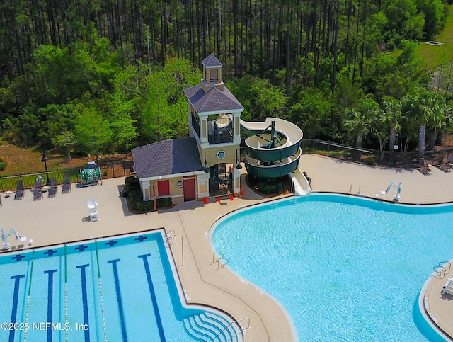 view of pool featuring a patio area and a water slide