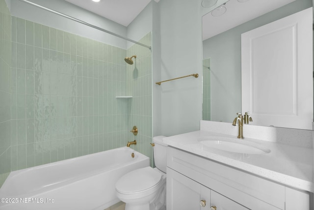 full bathroom with vanity, tiled shower / bath combo, and toilet