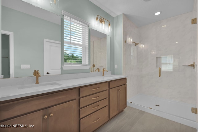 bathroom with vanity and a shower with door