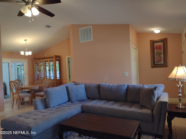 living room featuring lofted ceiling, light tile patterned floors, and ceiling fan with notable chandelier