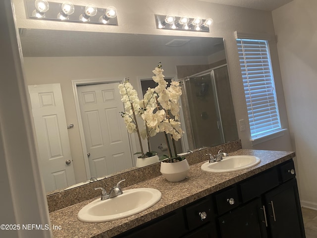 bathroom featuring an enclosed shower and vanity