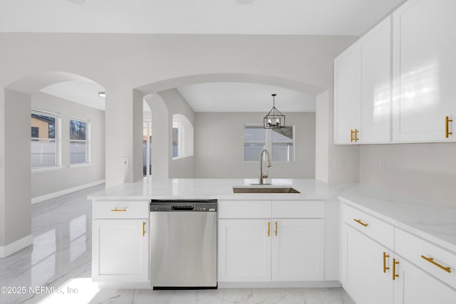 kitchen with light stone countertops, sink, white cabinets, and dishwasher