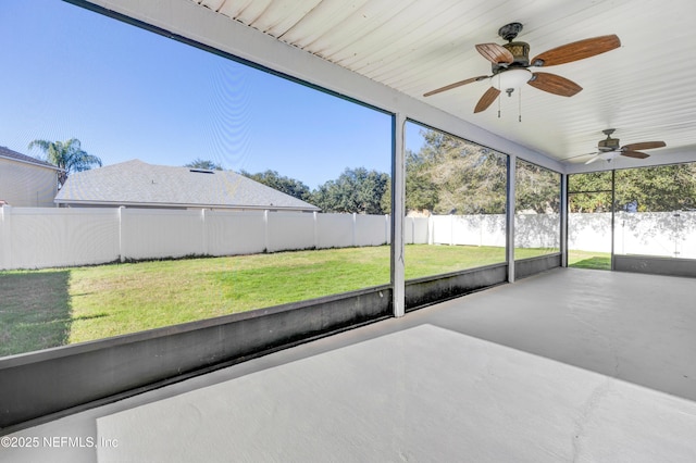 unfurnished sunroom with ceiling fan