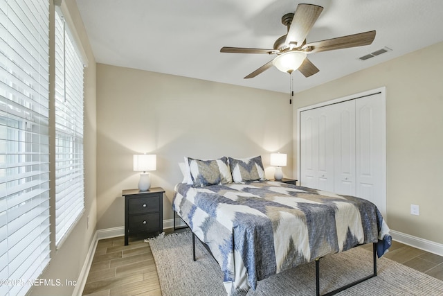 bedroom with ceiling fan and a closet