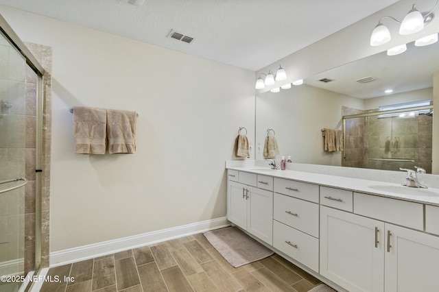 bathroom featuring walk in shower and vanity