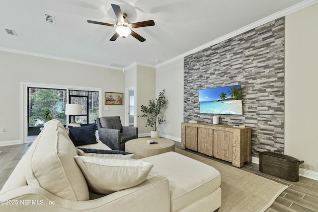 living room with ceiling fan and crown molding