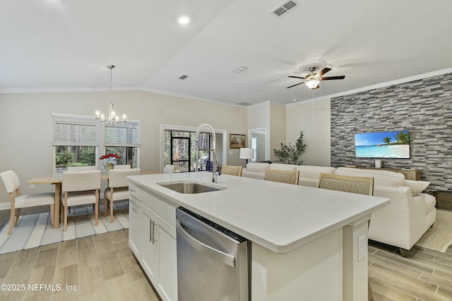 kitchen with white cabinetry, decorative light fixtures, a kitchen island with sink, vaulted ceiling, and stainless steel dishwasher