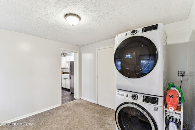 washroom with stacked washer / dryer, carpet flooring, and a textured ceiling