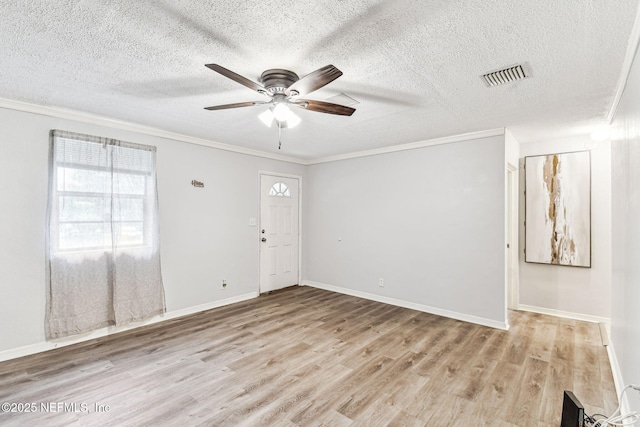 empty room with crown molding, ceiling fan, light hardwood / wood-style flooring, and a textured ceiling