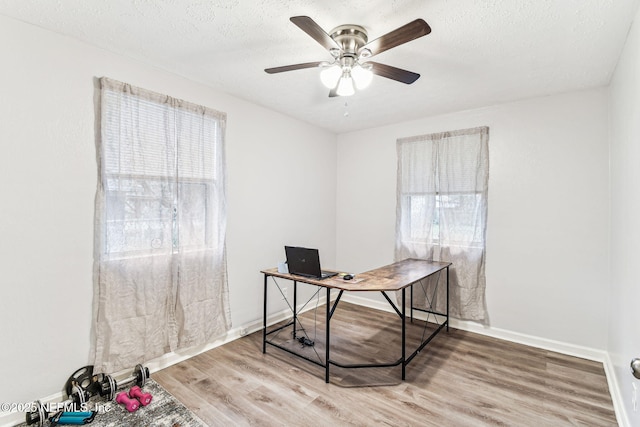 office with hardwood / wood-style floors, a textured ceiling, and ceiling fan