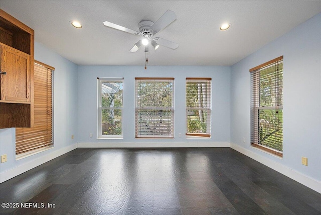 spare room with plenty of natural light and ceiling fan