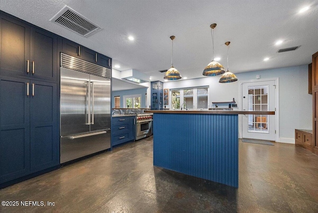 kitchen featuring a kitchen island, pendant lighting, blue cabinets, premium appliances, and a textured ceiling