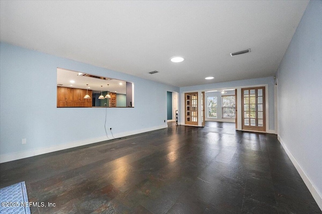 unfurnished living room featuring french doors