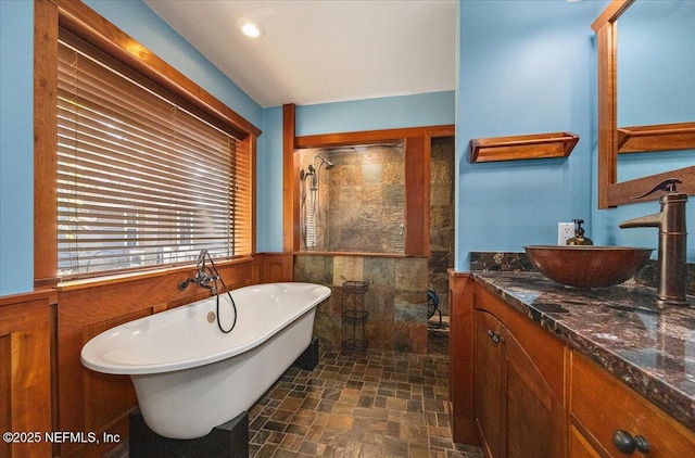 bathroom with vanity and separate shower and tub