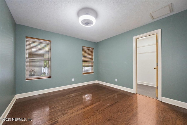 unfurnished room with dark hardwood / wood-style flooring