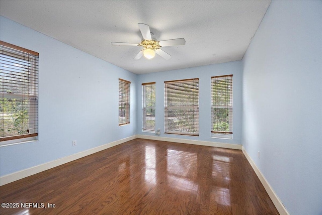 spare room with hardwood / wood-style floors, a textured ceiling, and ceiling fan