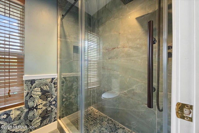 bathroom featuring a shower with shower door