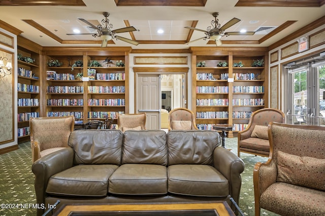 sitting room with carpet, ornamental molding, and built in shelves