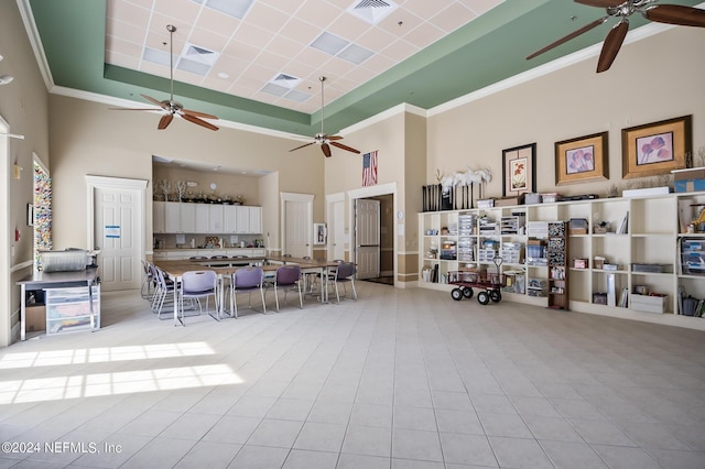 tiled living room with a raised ceiling and a high ceiling