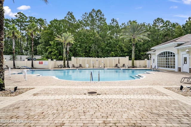 view of swimming pool with a patio