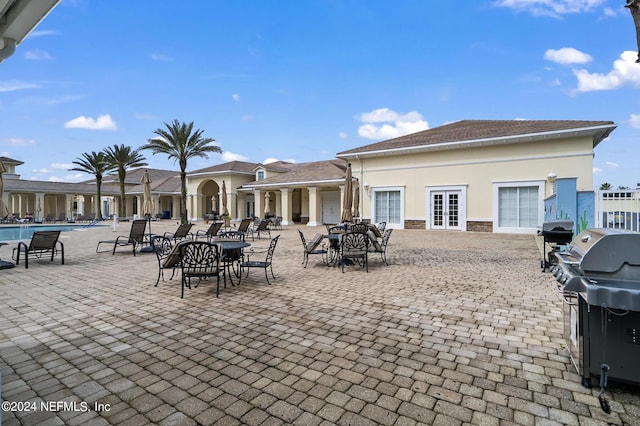 exterior space with a community pool and grilling area