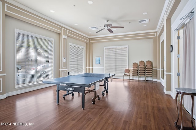 rec room with ceiling fan, dark hardwood / wood-style flooring, and crown molding