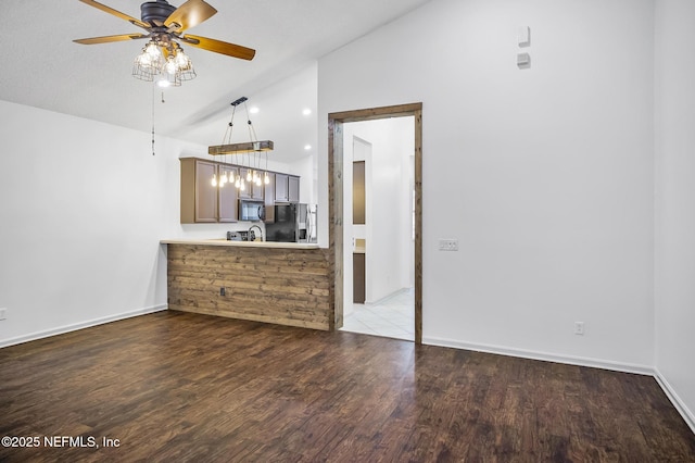 unfurnished living room featuring ceiling fan, wood-type flooring, and high vaulted ceiling