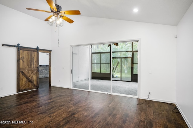 unfurnished room with ceiling fan, dark hardwood / wood-style floors, high vaulted ceiling, and a barn door