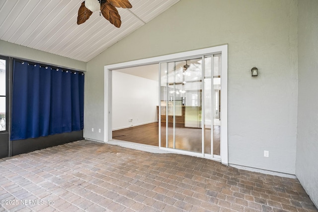 unfurnished room featuring ceiling fan and vaulted ceiling