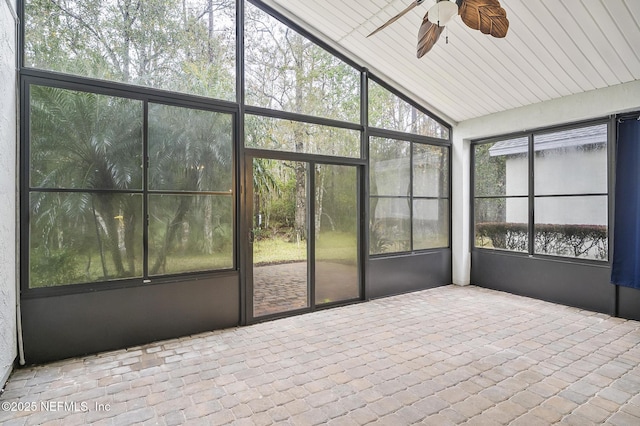 unfurnished sunroom with vaulted ceiling and ceiling fan