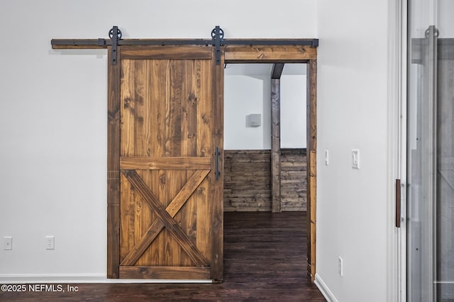 interior details featuring hardwood / wood-style flooring and a barn door