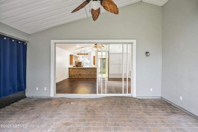 unfurnished room featuring vaulted ceiling with beams