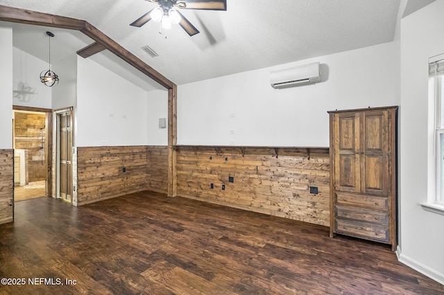 empty room with wooden walls, dark wood-type flooring, vaulted ceiling with beams, and an AC wall unit