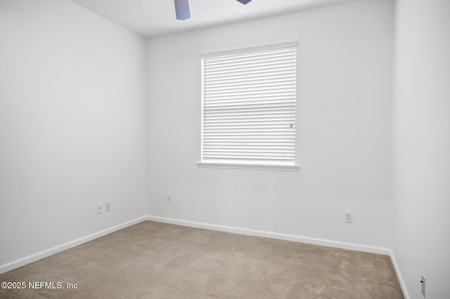 carpeted empty room featuring ceiling fan