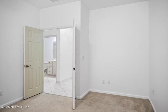 unfurnished bedroom featuring light colored carpet