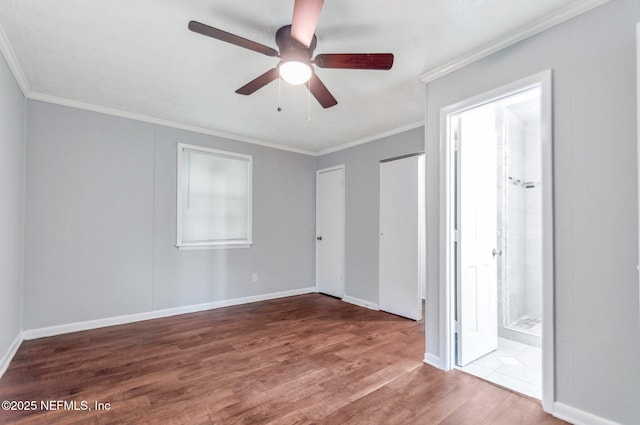 unfurnished bedroom with ceiling fan, hardwood / wood-style flooring, ensuite bathroom, and ornamental molding