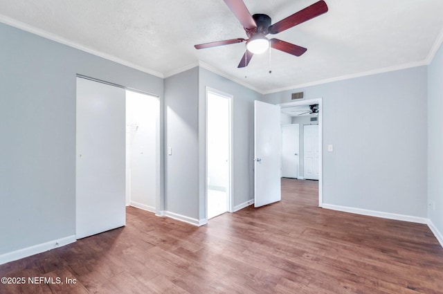 empty room with ceiling fan, crown molding, and hardwood / wood-style floors