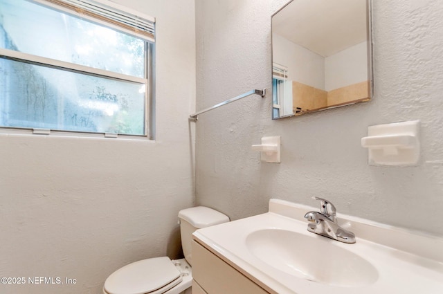 bathroom featuring toilet and vanity