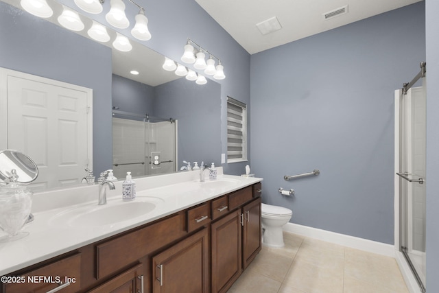 bathroom featuring vanity, toilet, tile patterned floors, and a shower with shower door