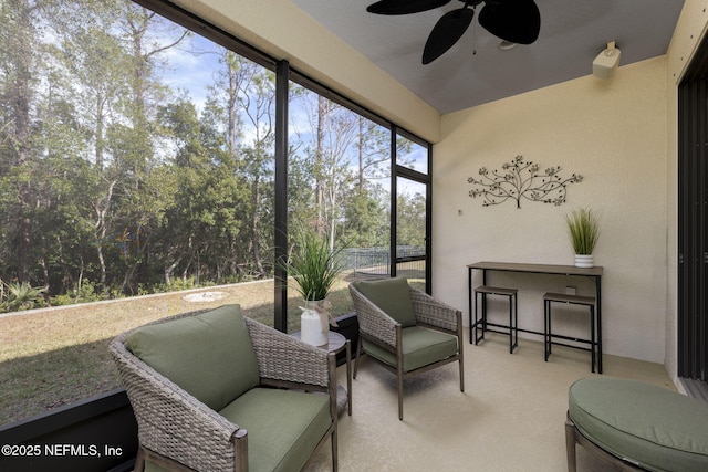 sunroom / solarium featuring ceiling fan