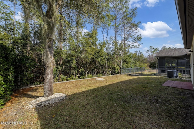 view of yard featuring central AC and a sunroom