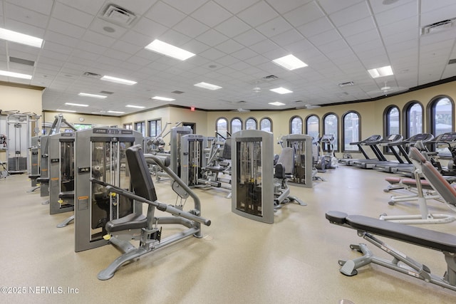 exercise room with a paneled ceiling