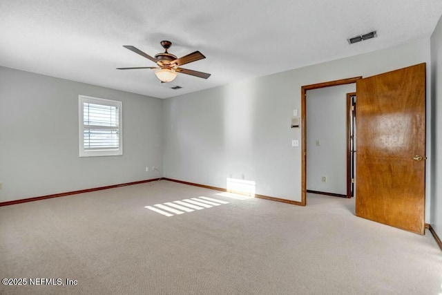 unfurnished room featuring light carpet and ceiling fan