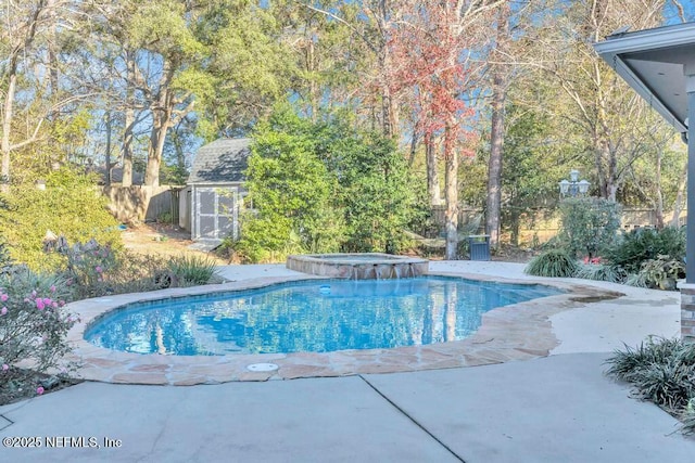 view of swimming pool with a shed and an in ground hot tub