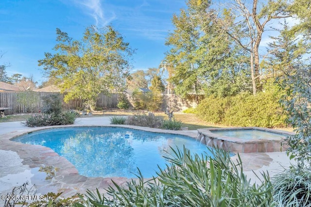 view of pool with an in ground hot tub