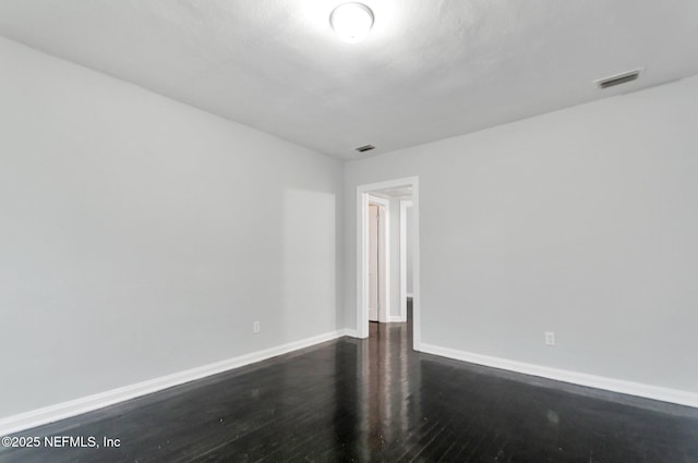 spare room featuring dark hardwood / wood-style floors