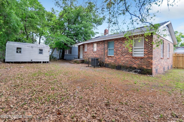 rear view of house featuring central AC